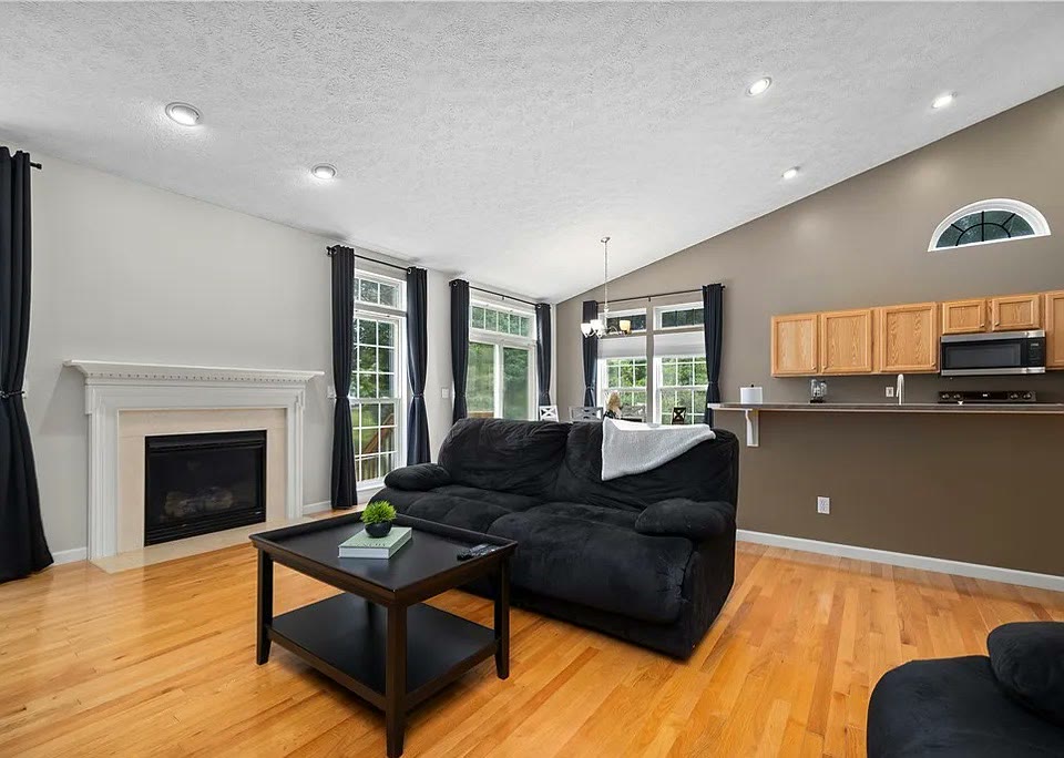 Living room with decorative fireplace and breakfast bar