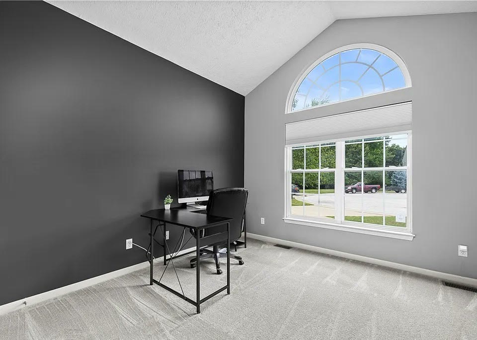 Second bedroom with a big arched window over Forestland Ct